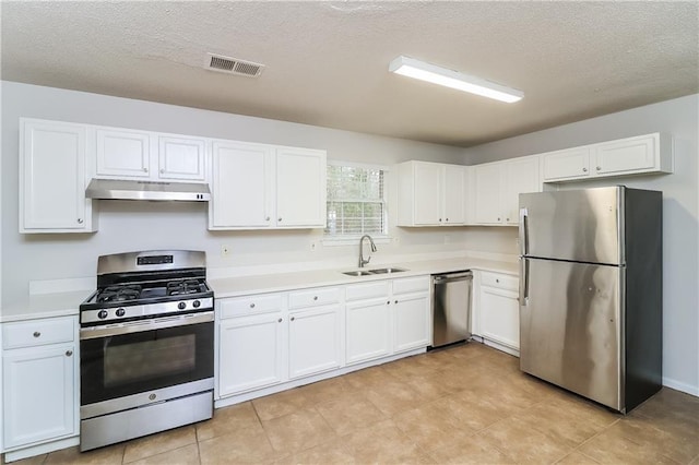 kitchen with sink, white cabinets, a textured ceiling, and appliances with stainless steel finishes