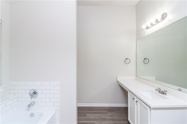 bathroom featuring a tub to relax in, vanity, and wood-type flooring