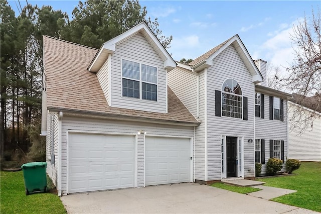 view of front facade with a garage and a front lawn