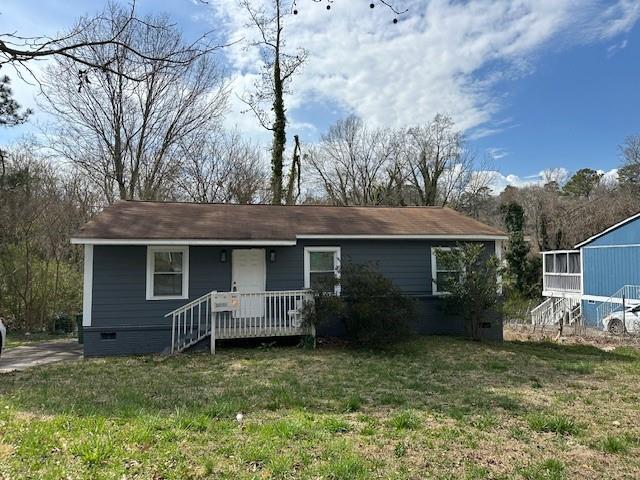 view of front of house with crawl space, covered porch, and a front lawn