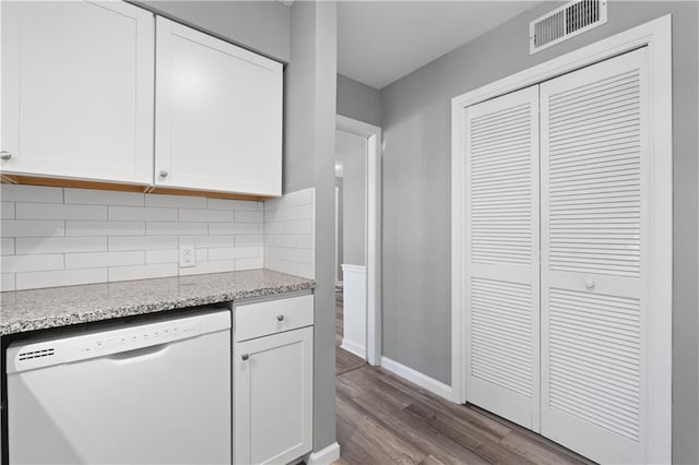 80 Montre Sq NW, Atlanta, GA 30327 - kitchen with white dishwasher, dark wood finished floors, white cabinets, and backsplash