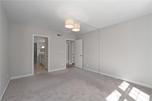 80 Montre Sq NW, Atlanta, GA 30327 - unfurnished bedroom featuring light carpet, baseboards, and ensuite bath
