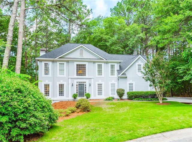 5396 Turnbill Pt NW, Acworth, GA 30101 - greek revival house featuring a front yard, a chimney, stucco siding, and a shingled roof
