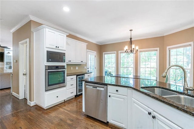 5396 Turnbill Pt NW, Acworth, GA 30101 - kitchen with appliances with stainless steel finishes, a chandelier, beverage cooler, dark wood finished floors, and crown molding