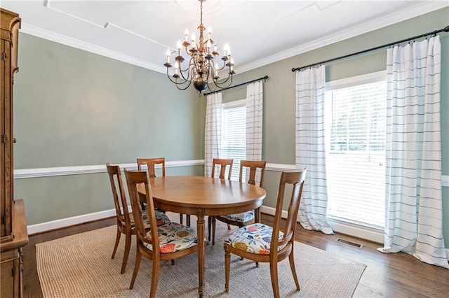 5396 Turnbill Pt NW, Acworth, GA 30101 - dining room with a chandelier, wood finished floors, and crown molding