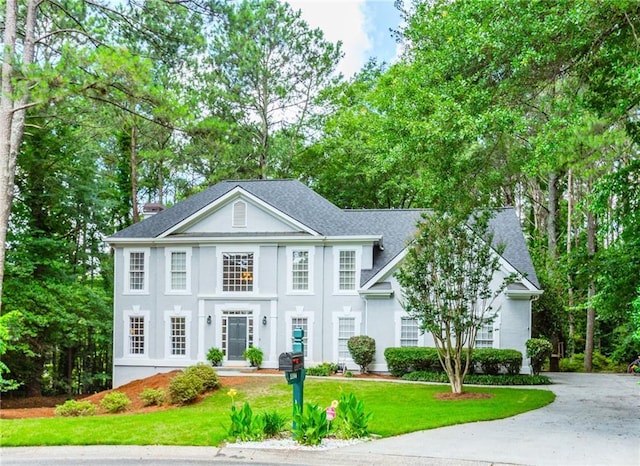 5396 Turnbill Pt NW, Acworth, GA 30101 - neoclassical home featuring a front yard, roof with shingles, and stucco siding