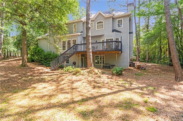 5396 Turnbill Pt NW, Acworth, GA 30101 - back of property with a deck, stairway, stucco siding, and a chimney