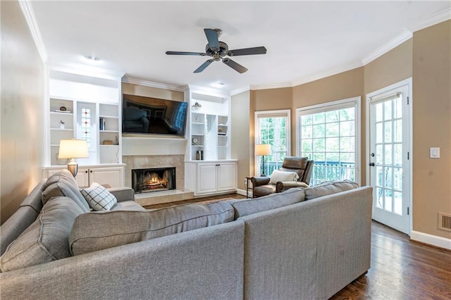 5396 Turnbill Pt NW, Acworth, GA 30101 - living room with crown molding, dark wood-style flooring, a ceiling fan, a high end fireplace, and built in shelves