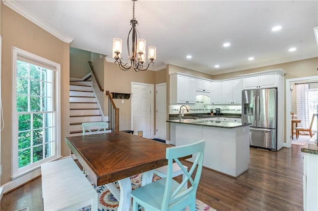 5396 Turnbill Pt NW, Acworth, GA 30101 - dining room with a chandelier, crown molding, dark wood finished floors, stairs, and recessed lighting