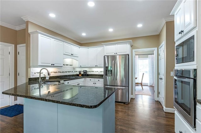 5396 Turnbill Pt NW, Acworth, GA 30101 - kitchen featuring stainless steel appliances, a peninsula, dark wood-type flooring, tasteful backsplash, and white cabinetry