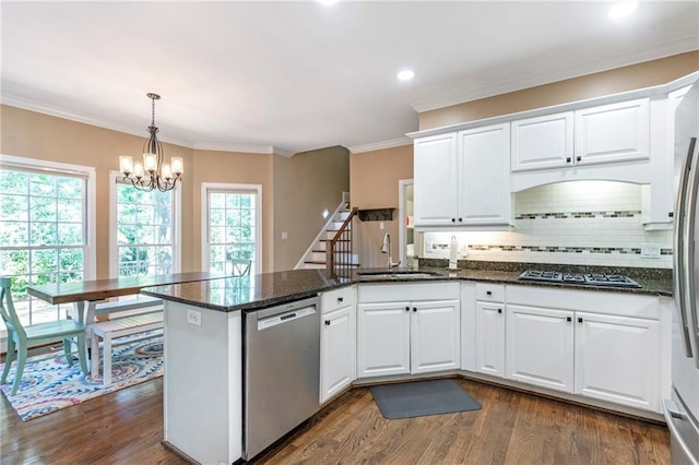 5396 Turnbill Pt NW, Acworth, GA 30101 - kitchen featuring dishwasher, gas stovetop, a peninsula, decorative backsplash, and dark wood-type flooring
