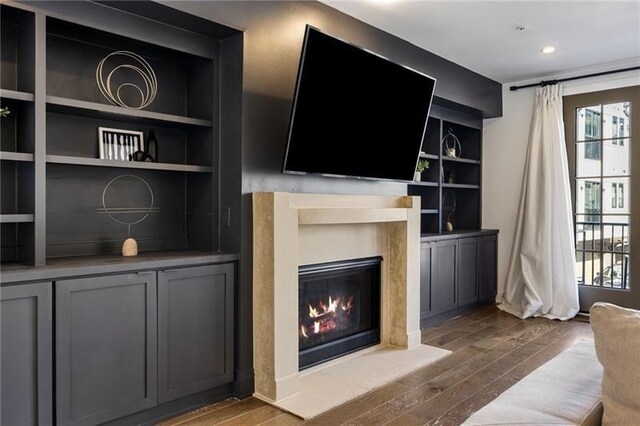 726 Edgewood Ave NE, Atlanta, GA 30307 - living area with a glass covered fireplace, built in features, a wealth of natural light, and dark wood finished floors