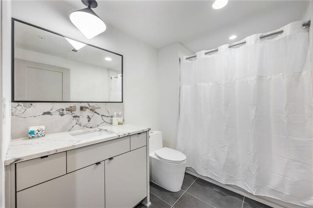 726 Edgewood Ave NE, Atlanta, GA 30307 - bathroom with vanity, tile patterned floors, tasteful backsplash, toilet, and a shower with shower curtain