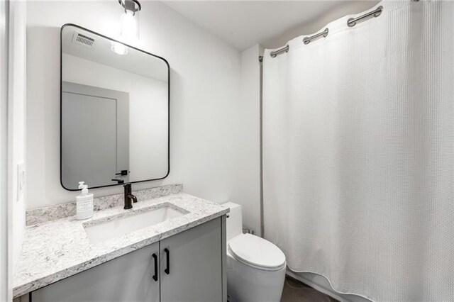 726 Edgewood Ave NE, Atlanta, GA 30307 - full bath with toilet, vanity, and a shower with shower curtain