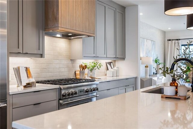 726 Edgewood Ave NE, Atlanta, GA 30307 - kitchen featuring high end stainless steel range oven, a sink, gray cabinetry, light countertops, and backsplash