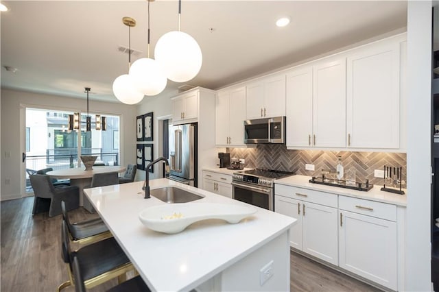 392 Pratt Dr Unit 2014, Atlanta, GA 30315 - kitchen featuring stainless steel appliances, white cabinetry, tasteful backsplash, light countertops, and recessed lighting
