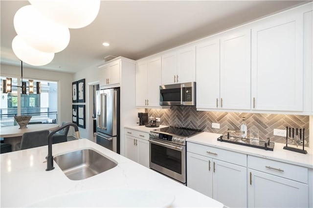 392 Pratt Dr Unit 2014, Atlanta, GA 30315 - kitchen with appliances with stainless steel finishes, backsplash, white cabinetry, pendant lighting, and recessed lighting