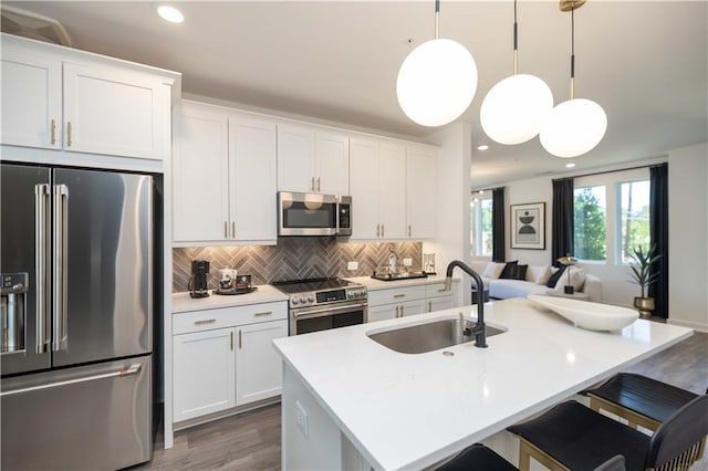 392 Pratt Dr Unit 2014, Atlanta, GA 30315 - kitchen with appliances with stainless steel finishes, wood finished floors, open floor plan, decorative backsplash, and white cabinets