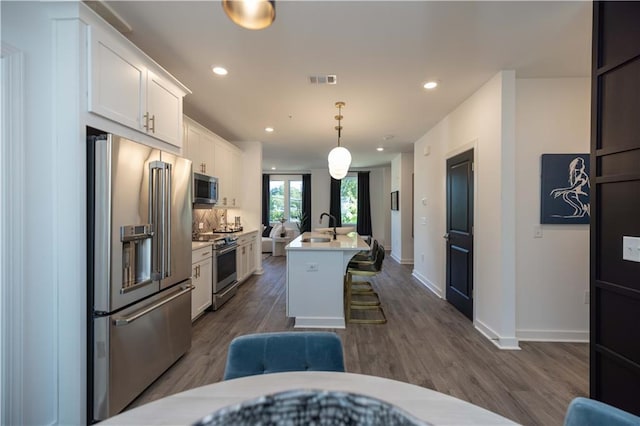 392 Pratt Dr Unit 2014, Atlanta, GA 30315 - kitchen featuring appliances with stainless steel finishes, white cabinetry, dark wood-style flooring, light countertops, and recessed lighting