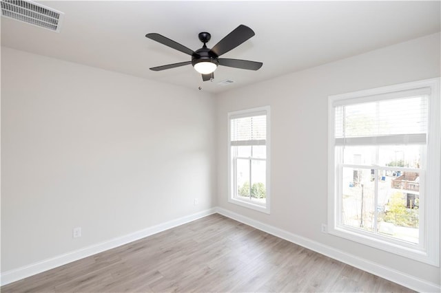 empty room with ceiling fan and light wood-type flooring