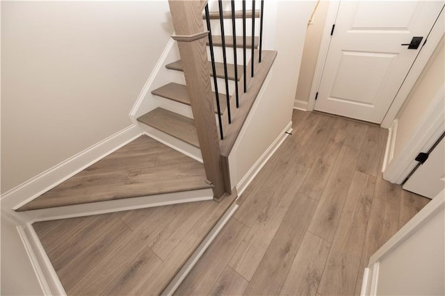 stairs with hardwood / wood-style flooring