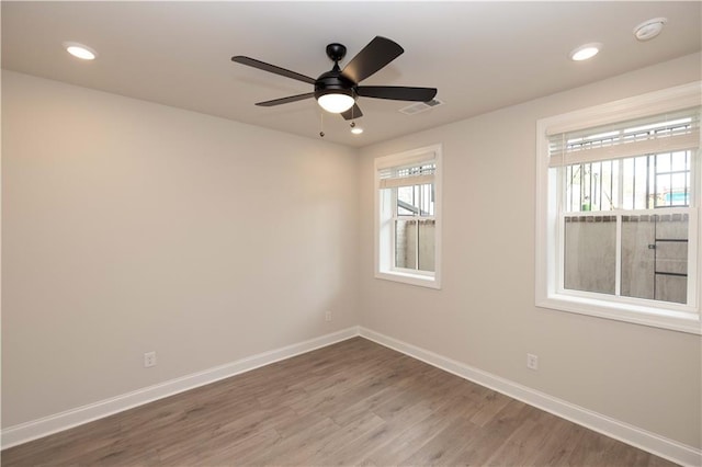 spare room with hardwood / wood-style floors and ceiling fan