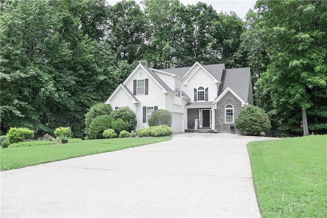 6985 Shane Ln, Cumming, GA 30028 - traditional-style house with driveway, stone siding, an attached garage, and a front yard