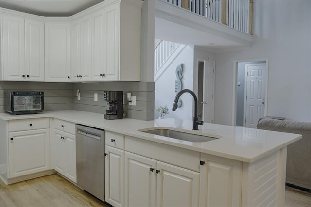 6985 Shane Ln, Cumming, GA 30028 - kitchen featuring dishwasher, a sink, light wood-type flooring, and white cabinets