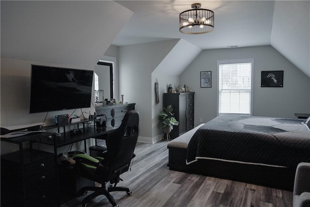 6985 Shane Ln, Cumming, GA 30028 - bedroom featuring wood finished floors, vaulted ceiling, and an office area
