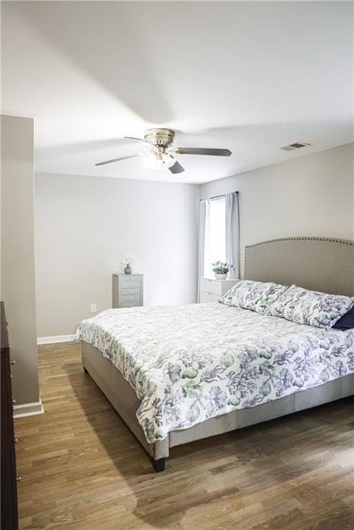 6985 Shane Ln, Cumming, GA 30028 - bedroom featuring wood finished floors, baseboards, and a ceiling fan