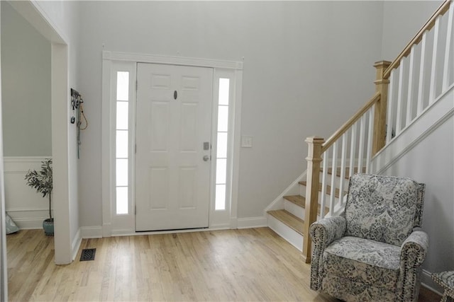 6985 Shane Ln, Cumming, GA 30028 - entryway with light wood-style floors, stairs, and baseboards