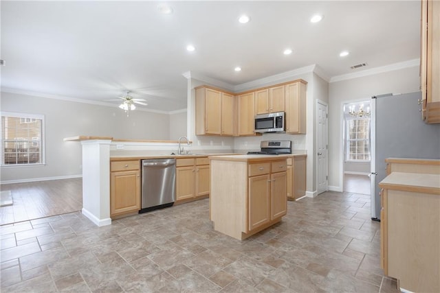 kitchen featuring stainless steel appliances, light brown cabinetry, a peninsula, and a healthy amount of sunlight