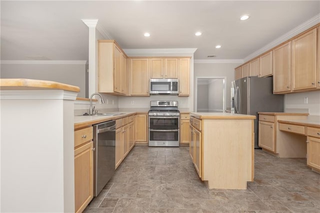 kitchen featuring a kitchen island, stainless steel appliances, light countertops, light brown cabinets, and a sink