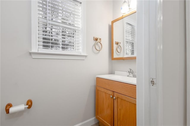 bathroom featuring baseboards and vanity