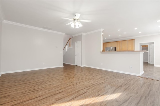 unfurnished living room featuring crown molding, light wood finished floors, stairway, and baseboards