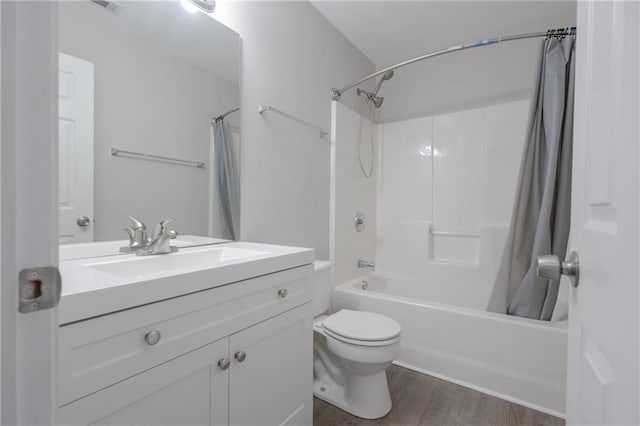 full bath featuring shower / bath combo, vanity, toilet, and wood finished floors