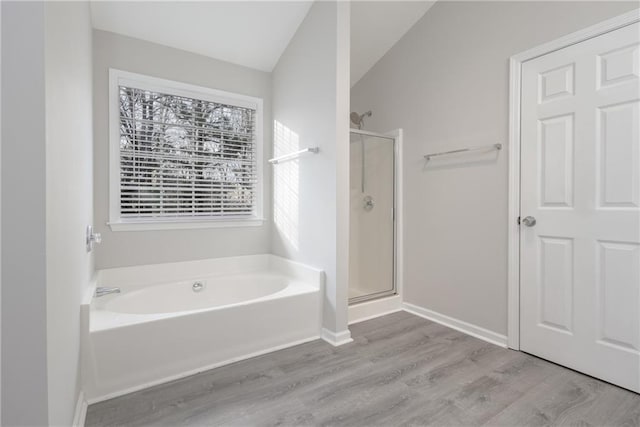 full bathroom featuring a garden tub, wood finished floors, and a shower stall