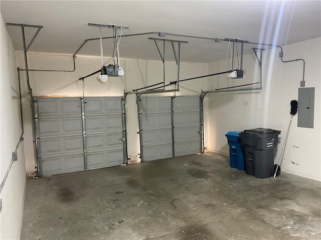 garage with a garage door opener and electric panel