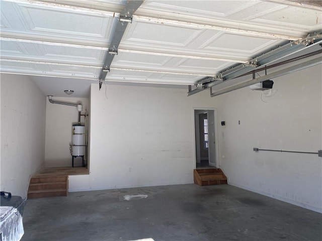 garage with water heater and a garage door opener