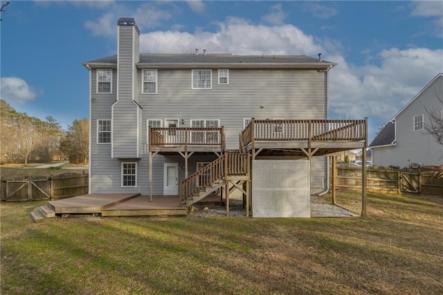 back of house featuring fence private yard, a lawn, a chimney, and a wooden deck