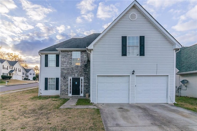 view of front of home with a lawn and a garage