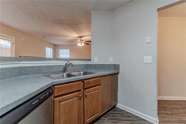 kitchen featuring dishwasher, a healthy amount of sunlight, dark hardwood / wood-style flooring, and sink