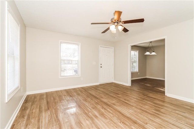 spare room featuring wood-type flooring and ceiling fan