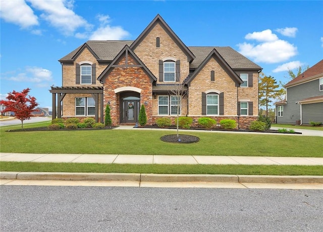 13 Clearwater Ct, Hoschton, GA 30548 - view of front of home with a front yard, brick siding, stone siding, and a pergola