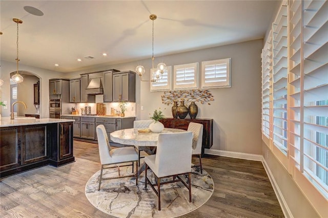 13 Clearwater Ct, Hoschton, GA 30548 - dining area featuring wood finished floors, plenty of natural light, a chandelier, and recessed lighting