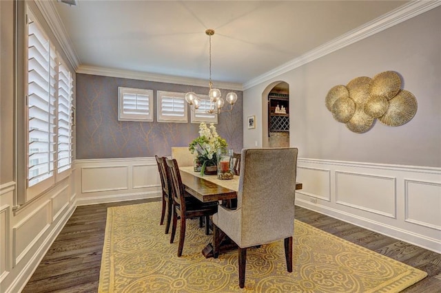 13 Clearwater Ct, Hoschton, GA 30548 - dining space with dark wood-style flooring, ornamental molding, a decorative wall, a chandelier, and a wainscoted wall