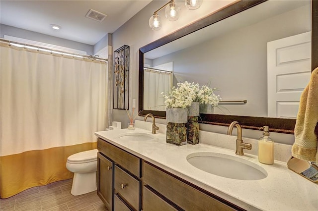 13 Clearwater Ct, Hoschton, GA 30548 - full bath featuring toilet, double vanity, and a shower with shower curtain