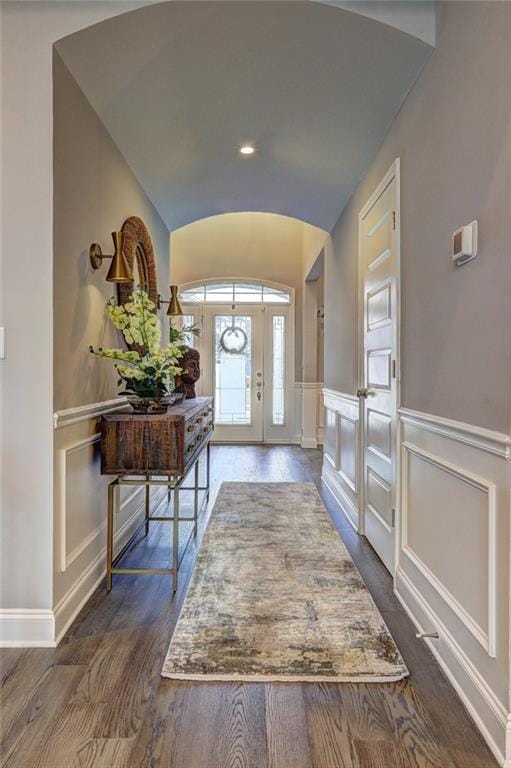 13 Clearwater Ct, Hoschton, GA 30548 - foyer with lofted ceiling, dark wood-style flooring, a decorative wall, wainscoting, and baseboards
