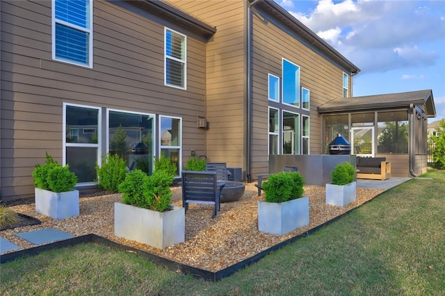 13 Clearwater Ct, Hoschton, GA 30548 - back of house featuring a sunroom and a lawn