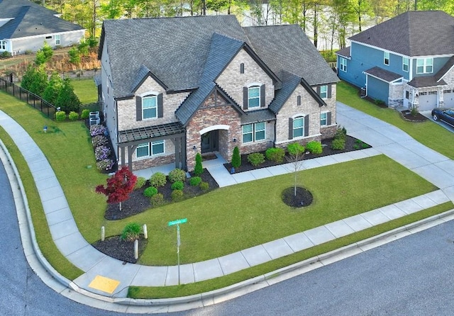 13 Clearwater Ct, Hoschton, GA 30548 - view of front of property featuring stone siding, a front lawn, and roof with shingles
